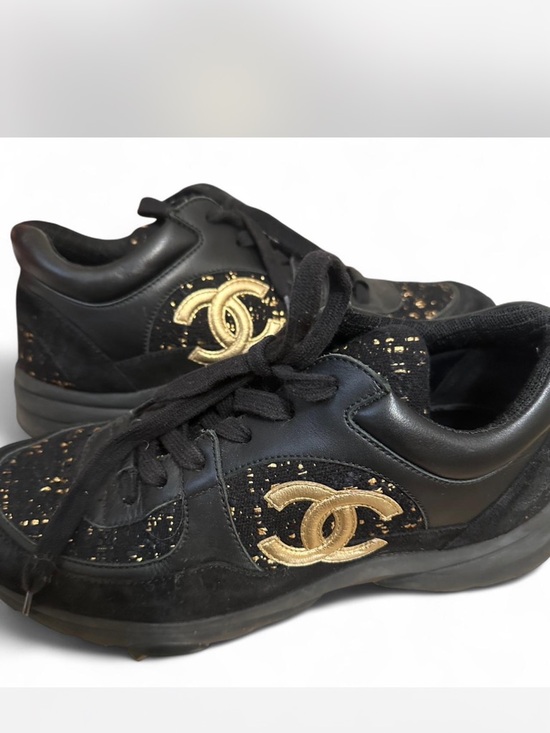 CHANEL Shoes - CHANEL Black and Gold Signature Logo Slip-On Sneakers